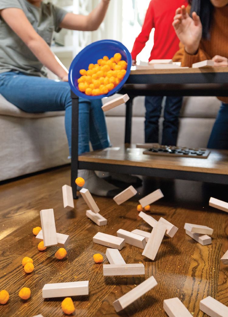 Family Game Night with toys on a hardwood floor.